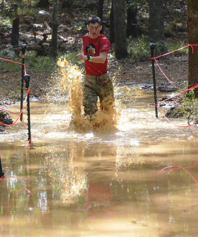 A Cadet from Huntington High School go for a dip in the trench on the Cross Country Rescue course during the JROTC Raider Nationals All-Army competition at the Gerald Lawhorn Boy Scout Camp in Molena, Georgia, Nov. 6. Cadets from across the country competed in the All-Army competition. (Photo by Michael Maddox, U.S. Army Cadet Command Public Affairs)