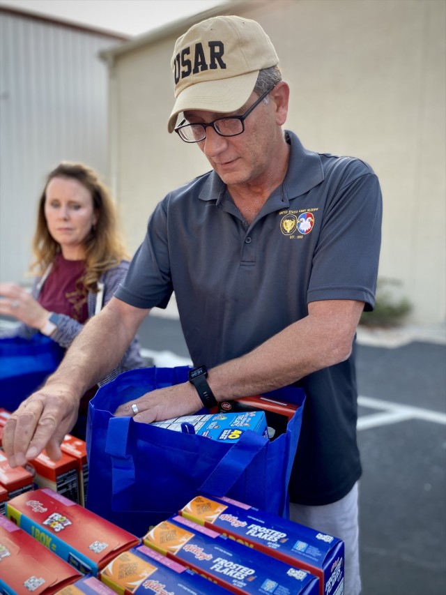 Mr. John McCarthy packs bags with food to be distributed during the Military Family Advisory Network’s 1 million meal challenge at Manna Church, Oct. 23, 2021.  (U.S. Army Reserve photo by Sgt. 1st Class Javier Orona)