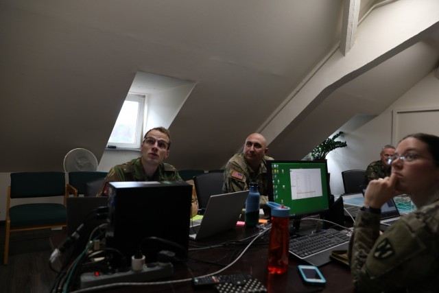 Dutch Second Lt. Daan Verwaaij (l), briefs 21st TSC Theater Movements Center Chief, Lt. Col. Scott Gum and 21st TSC host Nation Support's Capt. Katie McDougall (r) on the iHNS system. The web-based tool developed by the Netherlands is designed to...