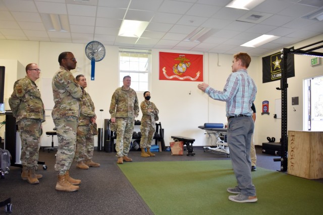 Dusty Hurd, right, supervisor of physical therapy at the California Medical Detachment’s Physical Therapy Clinic, speaks to, from right, Senior Master Sgt. Kristian Keahi, senior enlisted advisor of the 311th Training Squadron; Col. James Kievit, commandant of the Defense Language Institute Foreign Language Center; Command Sgt. Maj. Ernesto Cruz, senior enlisted adviser of the DLIFLC; Air Force Lt. Col. William Taylor, commander of the 311th Training Squadron; and Air Force Chaplain (Maj.) Kyle Roehrig, installation chaplain for the 517th Training Group, during a tour of the CalMed Physical Therapy Clinic in its new location in Bldg. 454, Presidio of Monterey, Calif., Nov. 9.