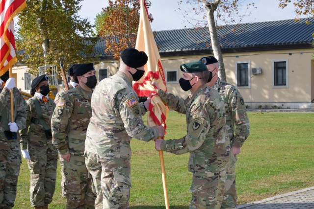 U.S. Army Command Sgt. Maj. Jonathan D. Dyon, incoming command Sgt. Maj. of U.S. Army Garrison Italy, receives the colors from Col. Matthew J. Gomlak, commander of U.S.A.G. Italy, during change of responsibility ceremony under Covid-19 prevention...