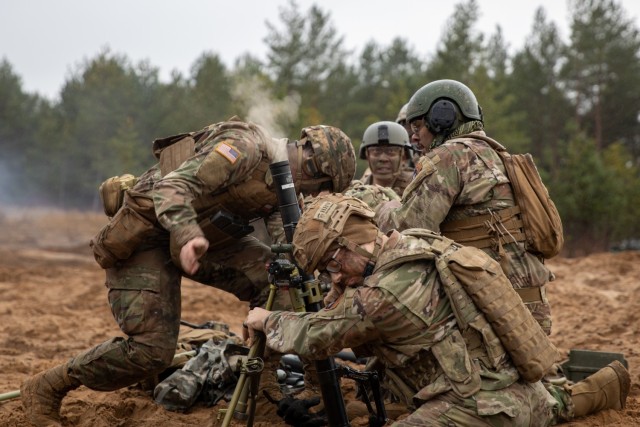 U.S. Army National Guard Soldiers with 3rd Battalion, 161st Infantry Regiment, fire a mortar during Rifle Forge, a live-fire exercise at Bemowo Piskie Training Area, Poland, Nov. 8, 2021. Rifle Forge was a culminating combined arms live-fire exercise that involved allies from Battle Group Poland. (U.S. Army photo by Pfc. Jacob Bradford)
