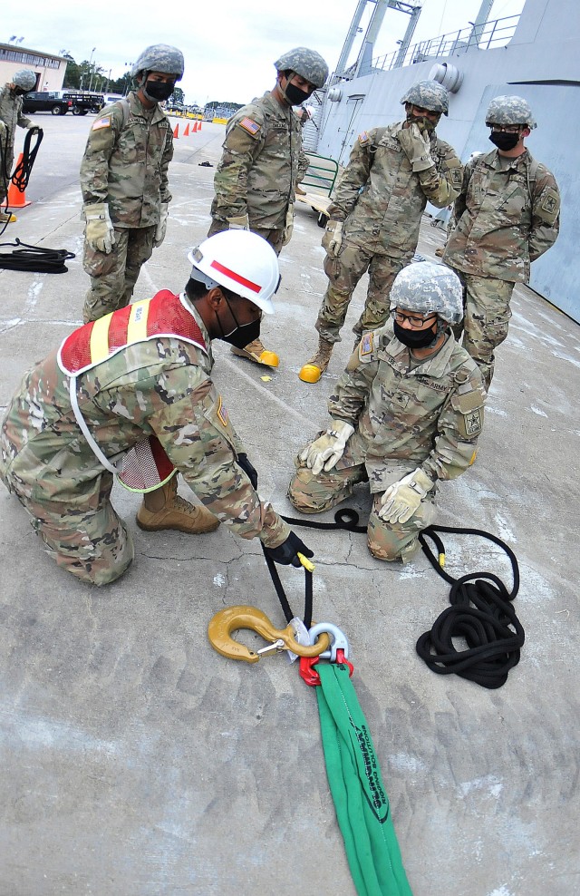 Staff Sgt. Quincey Chavis, an instructor with the 88H Cargo Specialist Course at Joint Base Langley-Eustis, demonstrates knot-tying techniques to students during training at 3rd Port Oct. 28. Knot tying is one of the many tasks taught during the...