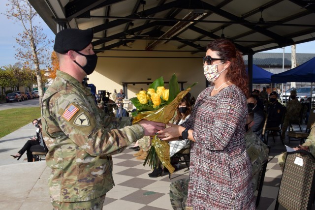 Mrs. Josie Dyon, wife to Command Sgt. Maj. Jonathan D. Dyon, incoming command Sgt. Maj. of U.S. Army Garrison Italy, is awarded yellow flowers during change of responsibility ceremony under Covid-19 prevention condition at Caserma Ederle, Vicenza,...