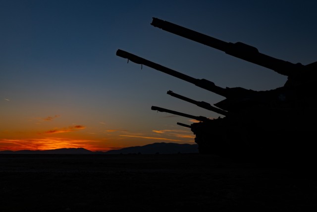 Hellenic Army Leopard A2 tanks and U.S. Army M1 Abram tanks with Charlie Company “Bandidos,” 1st Infantry Regiment, 1st Armored Brigade Combat Team, 1st Infantry Division, align together at sunset during closing ceremony rehearsals for the Hellenic Tank Challenge 2021, at Petrochori Range, Triantafyllides Camp, Greece, Nov. 4, 2021. The Hellenic Tank Challenge 2021 is a competition under Atlantic Resolve that helps enable deterrence and defense against regional threats in Eastern Europe. 