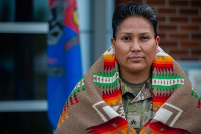 Sgt. Christina Chee, a water treatment specialist assigned to Alpha Company, 46th Aviation Support Battalion, poses for a photo with a traditional Pendleton Blanket while showcasing symbolic Navajo items during National Native American Heritage Month at Joint Base Lewis-McChord, Wash., Nov. 8, 2021. Chee is a member of the Navajo Tribe of Monument Valley, Utah and a second-generation Soldier.
(U.S. Army Photo by Staff Sgt. ShaTyra Reed, 16th Combat Aviation Brigade)