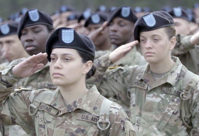 Stormy Gideons, front, and Trinity Carpenter render salutes during basic combat training at Fort Jackson South Carolina. 