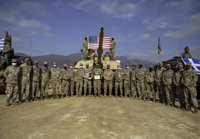 U.S. Army Soldiers with Charlie Company “Bandidos,” 1st Infantry Regiment, 1st Armored Brigade Combat Team, 1st Infantry Division, gather for a photo following the closing ceremony of the Hellenic Tank Challenge 2021, at Petrochori Range, Triantafyllides Camp, Greece, Nov. 5, 2021. The Hellenic Tank Challenge 2021 is a live-fire exercise between Greece and the United States to enhance tactical and operational cohesion among both militaries.