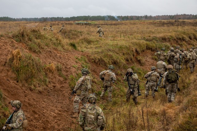 U.S. Army Soldiers with 3rd Battalion, 161st Infantry Regiment, prepare to clear a trench complex during Rifle Forge, a combined arms live-fire exercise at Bemowo Piskie Training Area, Poland, Nov. 8, 2021. The exercise tested Soldiers' ability to maneuver and work together to clear a trench complex. (U.S. Army photo by Pfc. Jacob Bradford)
