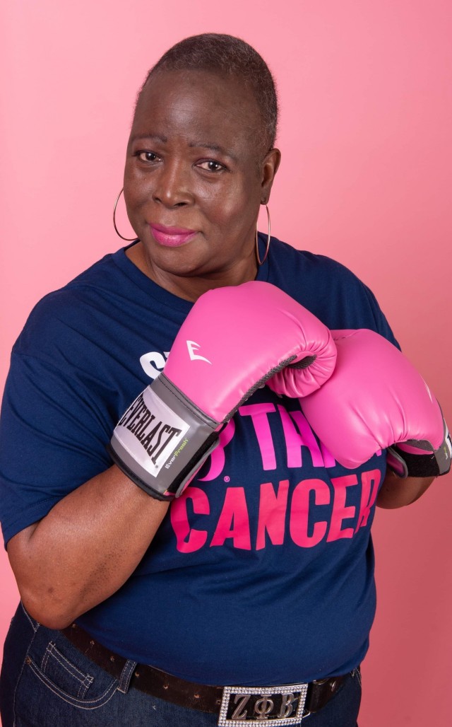 Leslie Wilson-Smith, a logistics manager for U.S. Army Tank-automotive and Armaments Command and two-year breast cancer survivor, wears her pink, “beat cancer” boxing gloves.