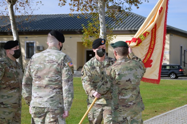 U.S. Army Command Sgt. Maj. Billy S. Vetten, outgoing command Sgt. Maj. of U.S. Army Garrison Italy, passes the colors to Col. Matthew J. Gomlak, commander of U.S.A.G. Italy, during change of responsibility ceremony under Covid-19 prevention...