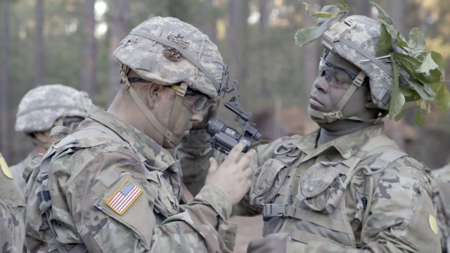 Leo Eades, right, assists fellow recruit Riley Barnard during a field training exercise.