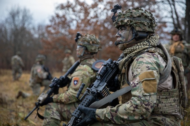 U.S. Army National Guard Soldiers with 3rd Battalion, 161st Infantry Regiment, kneel for a short halt during Rifle Forge, a live-fire exercise at Bemowo Piskie Training Area, Poland, Nov. 8, 2021. Rifle Forge was a culminating combined arms live-fire exercise that involves allies from Battle Group Poland. (U.S. Army photo by Pfc. Jacob Bradford)