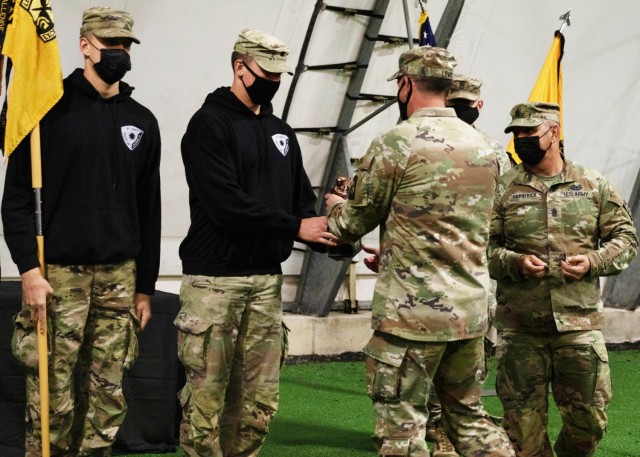 Col. Adam Lewis, 3rd ROTC Brigade commander, presents cadets from Minnesota’s Fighting Saints Battalion – comprised of students from Saint John’s University, The College of Saint Benedict and Saint Cloud State University – with a...