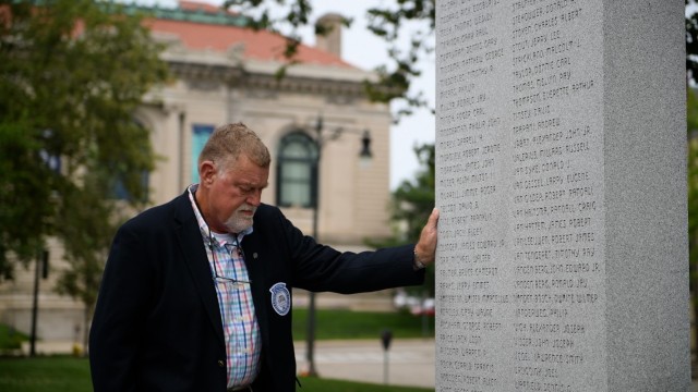 Former Army Honor Guard member Craig Smith takes a moment to remember fallen U.S. service members at a memorial in Grand Rapids, Mich. Smith served as a Sentinel and guarded the Tomb of the Unknown Soldier during the Vietnam War. 