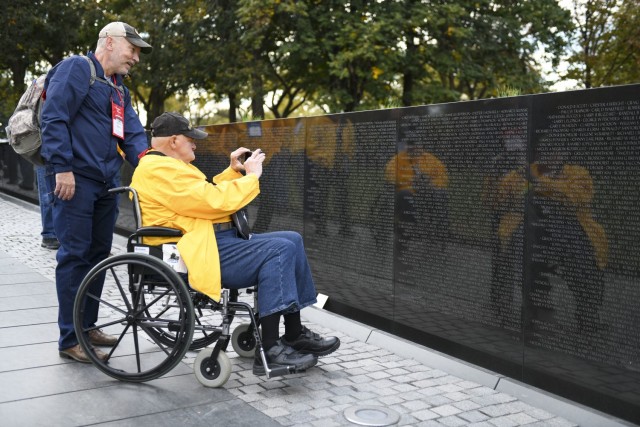 Peter Jones, a retired U.S. Army Soldier from Mount Pleasant, Iowa, and Michael Downey, a tour group volunteer, view the Vietnam Veterans Memorial in Washington Nov. 4, 2021. Jones, who served in Vietnam from 1968-1969, was in the Army and Iowa...