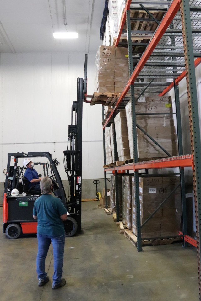Supply Specialist Tamra Meyer with the Fort McCoy Logistics Readiness Center (LRC) Food Program Management Office (right) prepares to check food content on a pallet Oct. 14, 2021, during food service operations at the LRC Supply Subsistence...