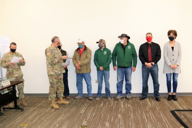 Members of the Fort McCoy workforce are shown being recognized for excellence Nov. 4, 2021, in the Installation Emergency Operations Center by Deputy Garrison Commander Lt. Col. Chad Maynard and Fort McCoy Garrison Commander Col. Michael Poss....