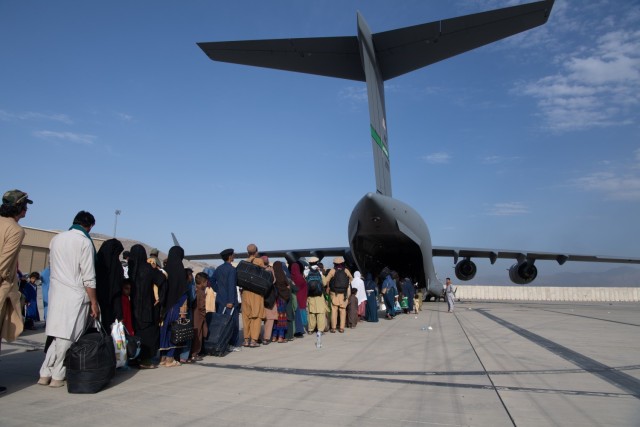 U.S. Air Force loadmasters and pilots assigned to the 816th Expeditionary Airlift Squadron, load passengers aboard a U.S. Air Force C-17 Globemaster III in support of the Afghanistan evacuation at Hamid Karzai International Airport (HKIA), Afghanistan, Aug. 24, 2021. (U.S. Air Force photo by Master Sgt. Donald R. Allen)