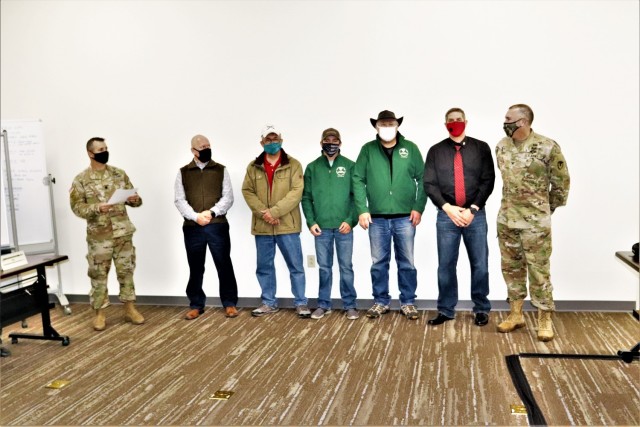 Members of the Fort McCoy workforce are shown being recognized for excellence Nov. 4, 2021, in the Installation Emergency Operations Center by Deputy Garrison Commander Lt. Col. Chad Maynard and Fort McCoy Garrison Commander Col. Michael Poss....