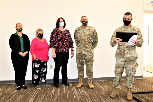 Members of the Fort McCoy Army Community Service office are shown being recognized for excellence Nov. 4, 2021, in the Installation Emergency Operations Center by Deputy Garrison Commander Lt. Col. Chad Maynard and Fort McCoy Garrison Commander...