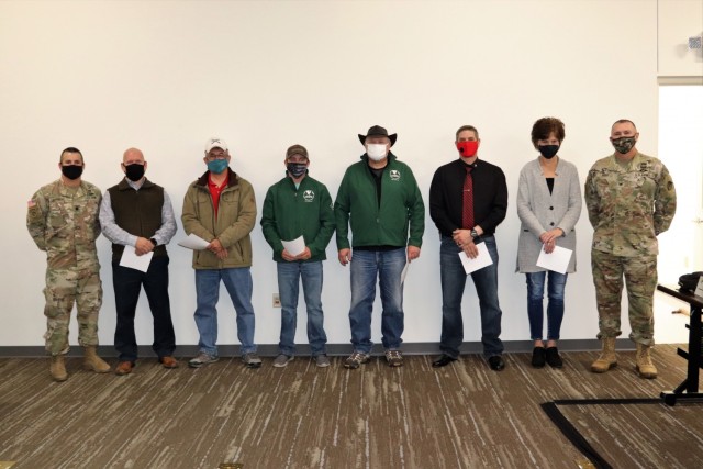Members of the Fort McCoy workforce are shown being recognized for excellence Nov. 4, 2021, in the Installation Emergency Operations Center by Deputy Garrison Commander Lt. Col. Chad Maynard and Fort McCoy Garrison Commander Col. Michael Poss....