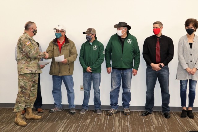 Members of the Fort McCoy workforce are shown being recognized for excellence Nov. 4, 2021, in the Installation Emergency Operations Center by Deputy Garrison Commander Lt. Col. Chad Maynard and Fort McCoy Garrison Commander Col. Michael Poss....