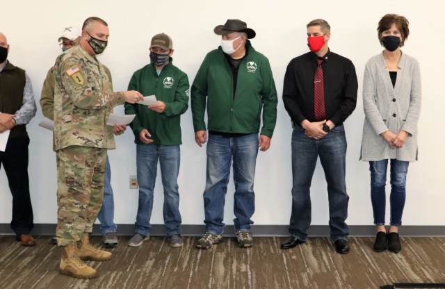 Members of the Fort McCoy workforce are shown being recognized for excellence Nov. 4, 2021, in the Installation Emergency Operations Center by Deputy Garrison Commander Lt. Col. Chad Maynard and Fort McCoy Garrison Commander Col. Michael Poss....