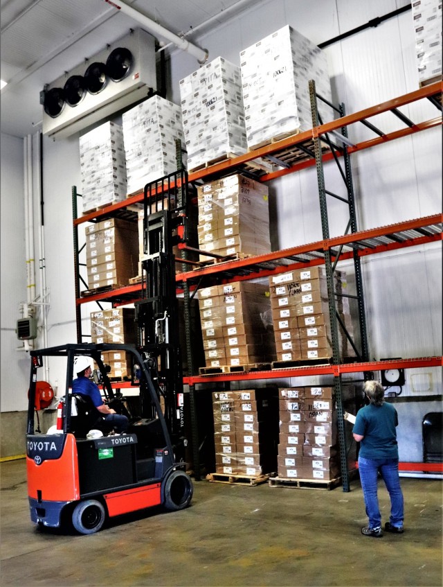 Supply Specialist Tamra Meyer with the Fort McCoy Logistics Readiness Center (LRC) Food Program Management Office (right) prepares to check food content on a pallet Oct. 14, 2021, during food service operations at the LRC Supply Subsistence...