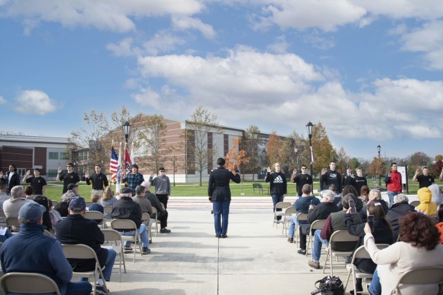 Eighteen new Army Soldiers take the oath of service in front of crowd of family, friends and regional Veterans at Veterans Day observation Nov. 11, 2021 at the U.S. Army Heritage and Education Center, home of the Army's History collection.