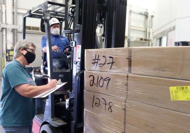 Supply Specialist Tamra Meyer with the Fort McCoy Logistics Readiness Center (LRC) Food Program Management Office (right) prepares to check food content on a pallet Oct. 14, 2021, during food service operations at the LRC Supply Subsistence...