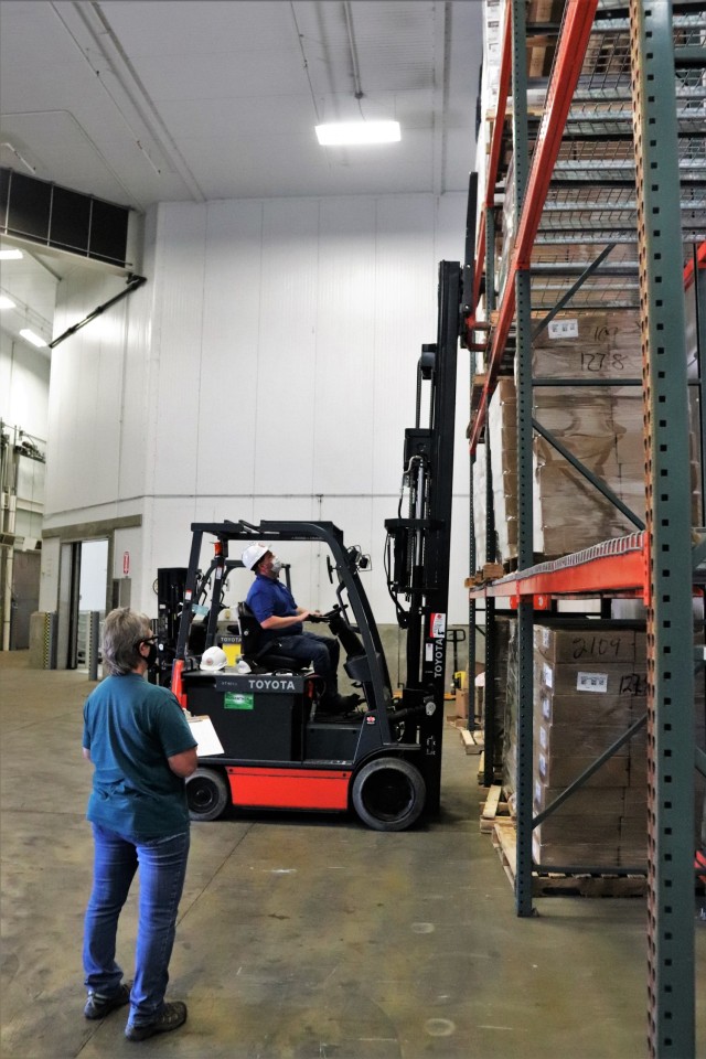 Supply Specialist Tamra Meyer with the Fort McCoy Logistics Readiness Center (LRC) Food Program Management Office (right) prepares to check food content on a pallet Oct. 14, 2021, during food service operations at the LRC Supply Subsistence...