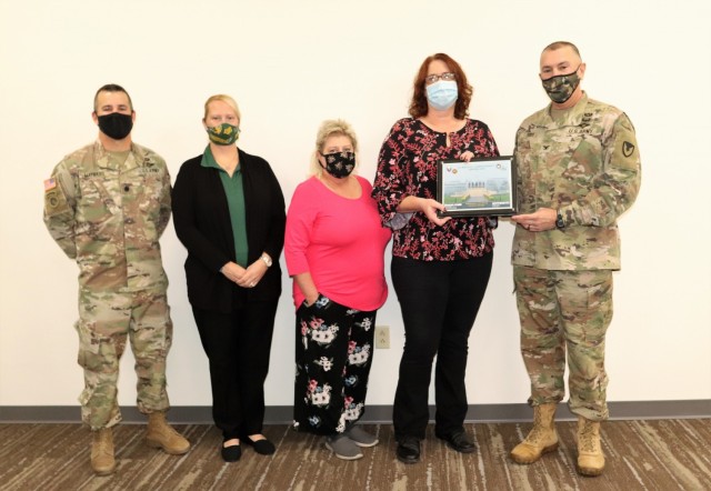 Members of the Fort McCoy Army Community Service office are shown being recognized for excellence Nov. 4, 2021, in the Installation Emergency Operations Center by Deputy Garrison Commander Lt. Col. Chad Maynard and Fort McCoy Garrison Commander...