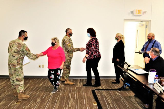 Members of the Fort McCoy Army Community Service office are shown being recognized for excellence Nov. 4, 2021, in the Installation Emergency Operations Center by Deputy Garrison Commander Lt. Col. Chad Maynard and Fort McCoy Garrison Commander...