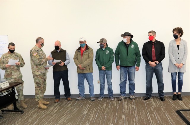 Members of the Fort McCoy workforce are shown being recognized for excellence Nov. 4, 2021, in the Installation Emergency Operations Center by Deputy Garrison Commander Lt. Col. Chad Maynard and Fort McCoy Garrison Commander Col. Michael Poss....