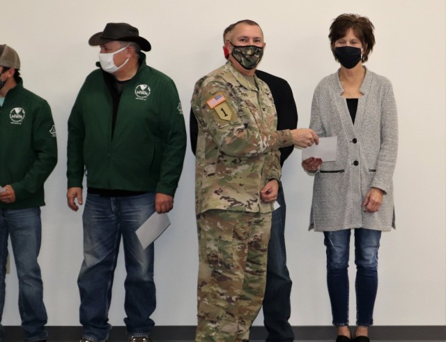 Members of the Fort McCoy workforce are shown being recognized for excellence Nov. 4, 2021, in the Installation Emergency Operations Center by Deputy Garrison Commander Lt. Col. Chad Maynard and Fort McCoy Garrison Commander Col. Michael Poss....
