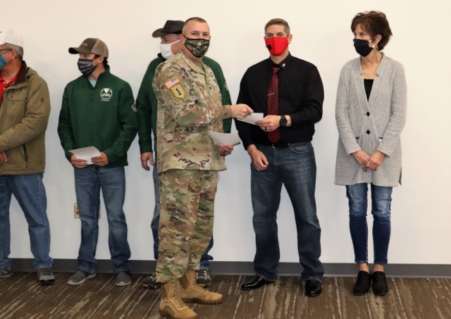 Members of the Fort McCoy workforce are shown being recognized for excellence Nov. 4, 2021, in the Installation Emergency Operations Center by Deputy Garrison Commander Lt. Col. Chad Maynard and Fort McCoy Garrison Commander Col. Michael Poss....