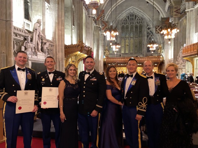 From left, Chief Warrant Officer 5 Joe Rosamond, Chief Warrant Officer 2 Bradley Hlebain, Falicia Ramos, Chief Warrant Officer 2 Irvin Hernandez, Pangia Xiong, Warrant Officer 1 Ge Xiong, Chief Warrant Officer 5 Kipp Goding and Jill Goding pose...