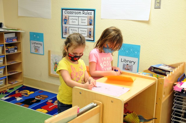 Enjoying the classroom time, two girls put their artistic ability to the test following the reopening of Youth Services during the Summer of 2021 at Yuma Proving Ground.