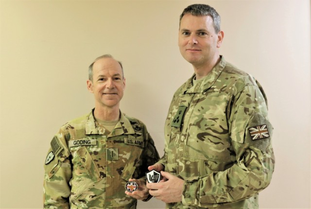 Chief Warrant Officer 5 Kipp Goding and Deputy Commanding General for Combined Joint Task Force – Operation Inherent Resolve Brigadier Richard Bell pose for a photo after exchanging coins at Camp Buehring, Kuwait. Bell was instrumental in getting Goding to leave theater to receive the Prince Philip Helicopter Rescue Award by the Honourable Company of Air Pilots in London  for rescuing campers and hikers from the Creek Fire in California in 2020.