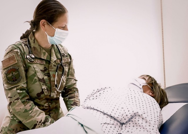 U.S. Air Force Maj. Leslie Balcazar, chief, midwifery services, Landstuhl Regional Medical Center, evaluates a patient during a routine exam at LRMC's Obstetrics and Gynecology Clinic, Nov. 3. Balcazar, a breast cancer survivor, shared her battle with one of the deadliest cancers for women in various platforms throughout October, Breast Cancer Awareness Month.