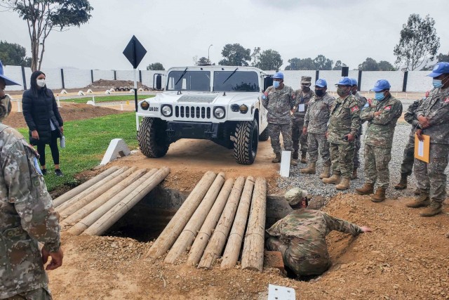 West Virginia National Guardsmen show members of the Peruvian military how to do field maintenance of Humvees in Lima, Peru. The Peruvian soldiers deployed as part of an international peacekeeping mission in the Central African Republic. (Courtesy photo)