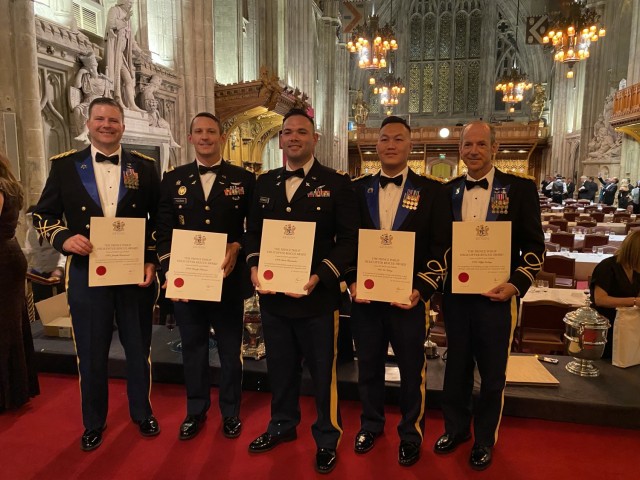 From left, Chief Warrant Officer 5 Joe Rosamond, Chief Warrant Officer 2 Bradley Hlebain, Chief Warrant Officer 2 Irvin Hernandez, Warrant Officer 1 Ge Xiong and Chief Warrant Officer 5 Kipp Goding display their Prince Philip Helicopter Rescue Awards at Guildhall in London on Oct. 21, 2021. The California National Guard members received the awards from the Honourable Company of Air Pilots for their actions rescuing campers and hikers from the Creek Fire in California on Labor Day weekend in 2020. (U.S. Army National Guard photo courtesy of Chief Warrant Officer 5 Joe Rosamond)