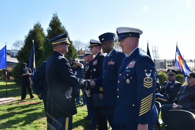 Col. Craig Martin, Fort Hamilton Garrison Commander recognizes the guest speakers during Veterans Day ceremony held outside the Community Club on Fort Hamilton, N.Y., Nov. 10, 2021. The ceremony celebrated the legacy and accomplishments of those who answered the call to service.