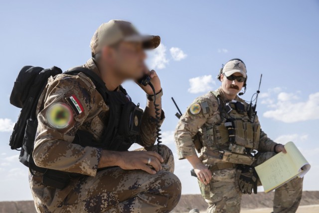 An Iraqi Tactical Attack Controller (ITAC) (left) from the Counter Terrorism Services practices calling an air strike on the radio near Al Asad Air Base, Iraq during Exercise Phoenix Fires Oct. 19, 2021. The exercise partnered Coalition Joint Terminal Attack Controllers (JTAC) with ITACs to enhance Iraqi forces’ ability to engage in close air support. (U.S. Army Photo by Staff SGT Jose A. Torres, Jr.)