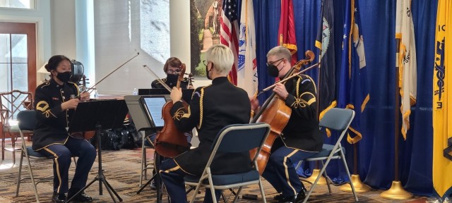 (Left to right) SFC Judith Cho (violin), MSG Annette Barger (violin), SSG Grant Ludwig (cello), and MSG Beth Waltenta (viola), performs for a Veterans Day commemoration at Knollwood Retirement Community, November 9, 2021. The concert is intended to be uplifting for long retired veterans.