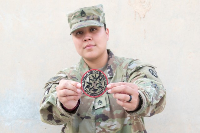 Staff Sgt. Jassmine J. Thornton, an automated logistics specialist assigned to the Fort Bragg, North Carolina, based 3rd Expeditionary Sustainment Command, shows off a patch on Nov. 4, 2021, at Camp Arifjan, Kuwait. Thornton said she is proud of...