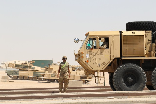 U.S. Soldiers with the 28th Expeditionary Combat Aviation Brigade and 40th Combat Aviation Brigade receive trucks and other equipment belonging to the 40th CAB as they arrive in the Middle East.