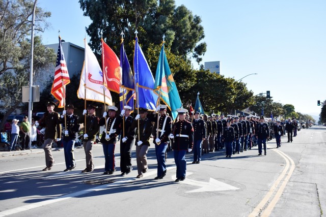 The Presidio of Monterey Joint Service Color Guard and dozens of PoM service members march in the 11th Annual Veterans Day Parade in Salinas, Calif., Nov. 11.