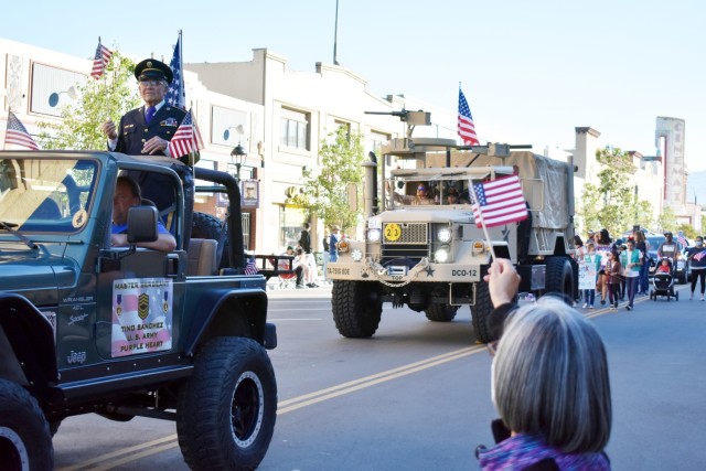 A woman waves a flag during the 11th Annual Veterans Day Parade in Salinas, Calif., Nov. 11.